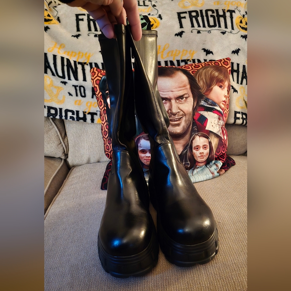 KILLSTAR platform boots featuring branded heel straps and skull graphic